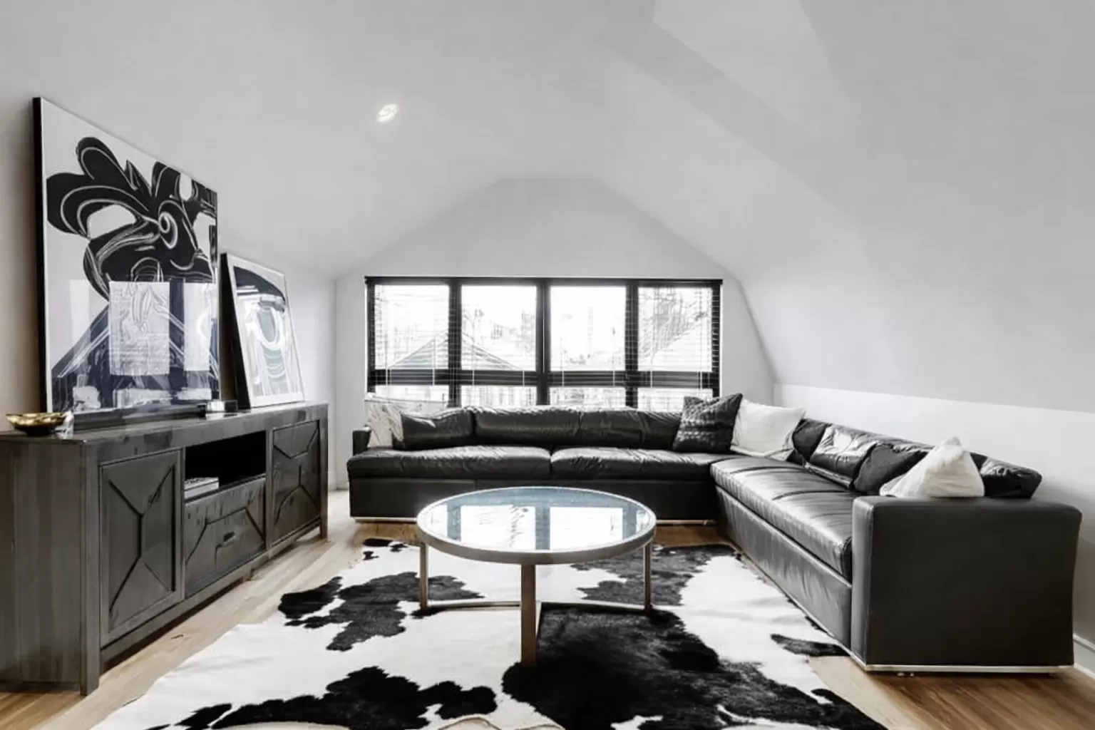 Black and white cowhide rug in a refined living room
